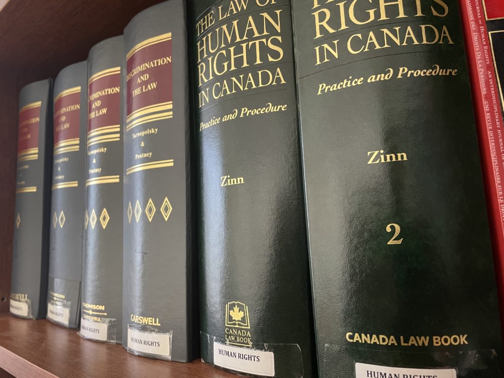 Books relating to human rights on a library shelf
